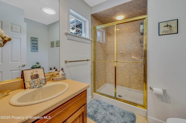 bathroom featuring vanity and a shower with door