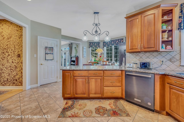 kitchen featuring tasteful backsplash, hanging light fixtures, stainless steel dishwasher, light tile patterned floors, and light stone counters