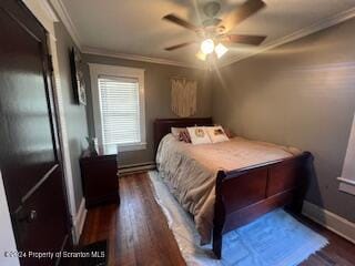 bedroom with ceiling fan, dark hardwood / wood-style flooring, ornamental molding, and baseboard heating