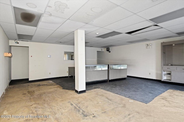 basement with a paneled ceiling