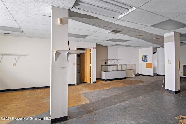 basement featuring a paneled ceiling