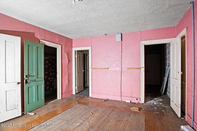 unfurnished room with a textured ceiling