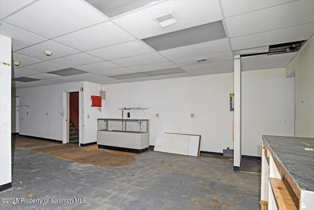 basement featuring a paneled ceiling