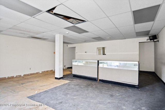 basement with a paneled ceiling