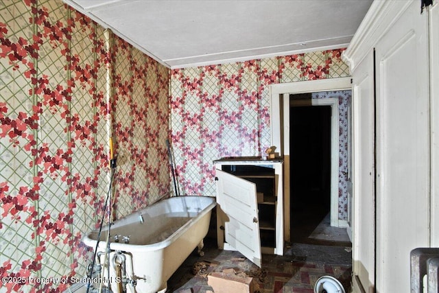 bathroom featuring ornamental molding and a bathtub