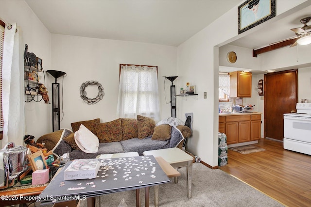 living room featuring light wood-type flooring and a ceiling fan