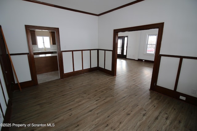 unfurnished room with dark wood-type flooring and crown molding