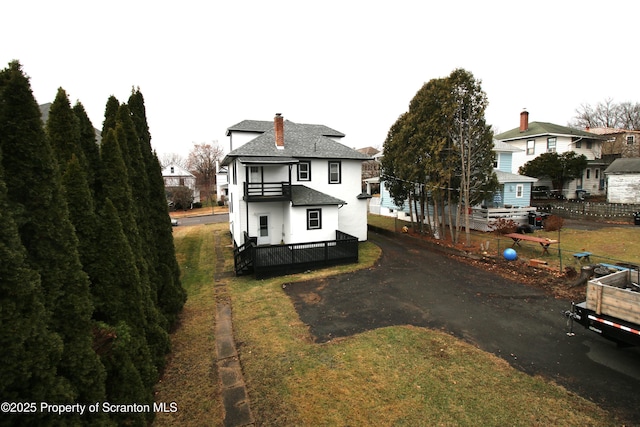 rear view of house with a lawn