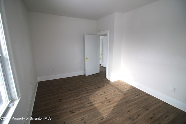 unfurnished room featuring dark hardwood / wood-style flooring