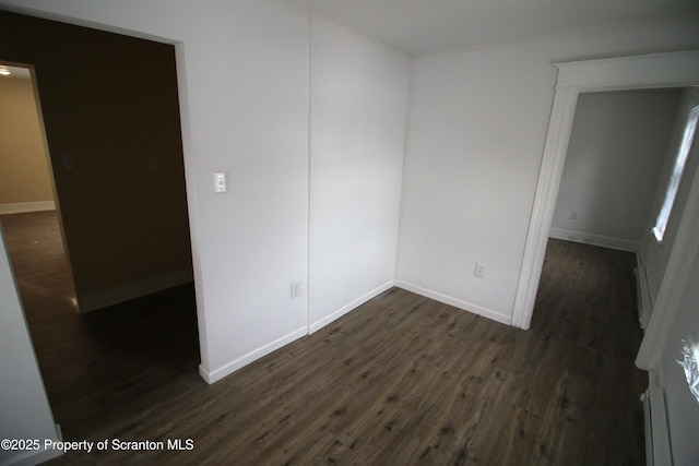 spare room featuring dark hardwood / wood-style flooring