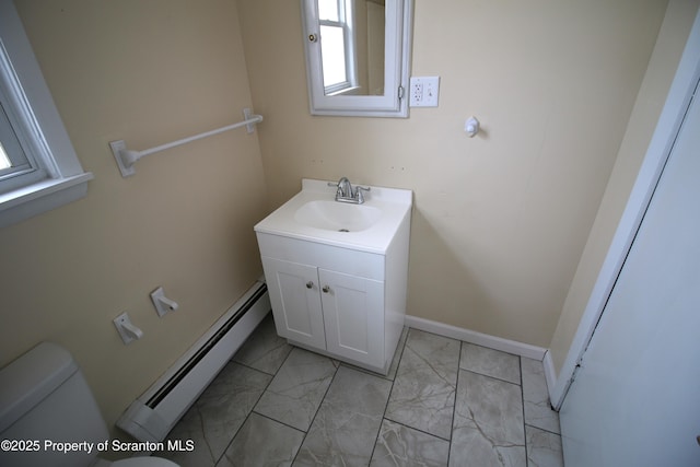 bathroom with toilet, baseboard heating, and vanity