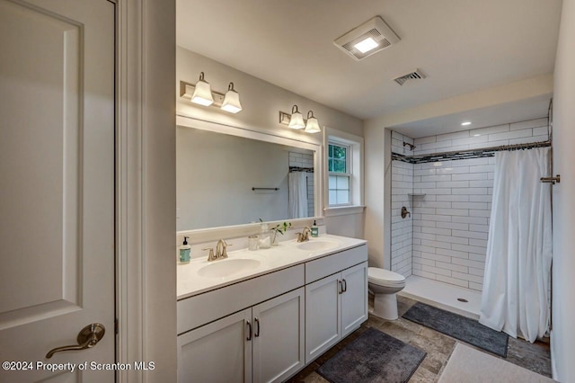 bathroom with curtained shower, vanity, and toilet