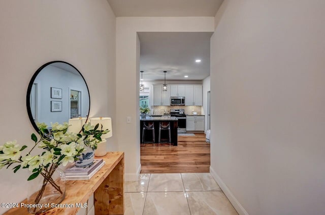 hallway featuring light tile patterned floors