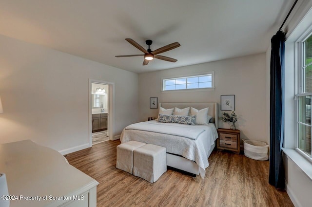 bedroom with connected bathroom, ceiling fan, and hardwood / wood-style floors