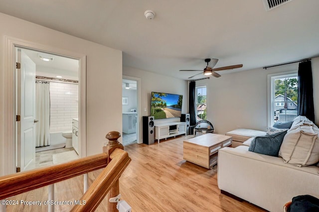 living room featuring ceiling fan and light hardwood / wood-style flooring