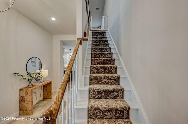 stairway featuring tile patterned floors