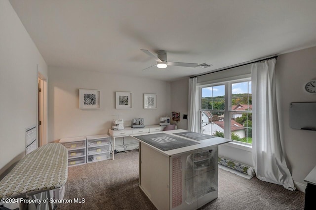 carpeted office space featuring ceiling fan