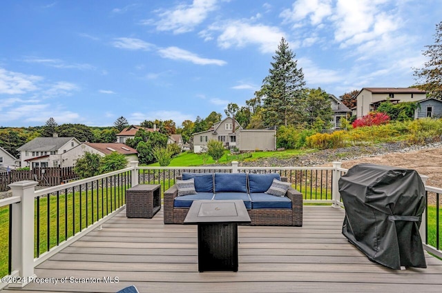 wooden deck featuring area for grilling, an outdoor living space, and a yard