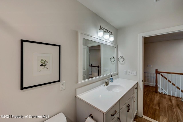 bathroom with hardwood / wood-style floors and vanity