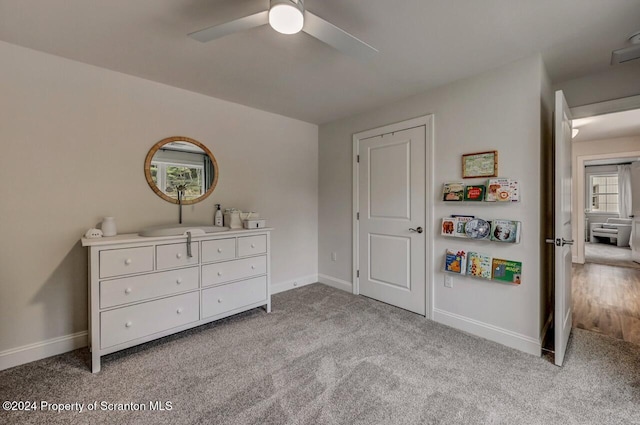 bedroom featuring ceiling fan and light colored carpet