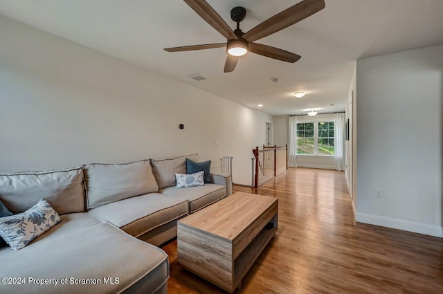 living room with hardwood / wood-style floors and ceiling fan