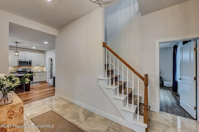 stairs featuring tile patterned floors