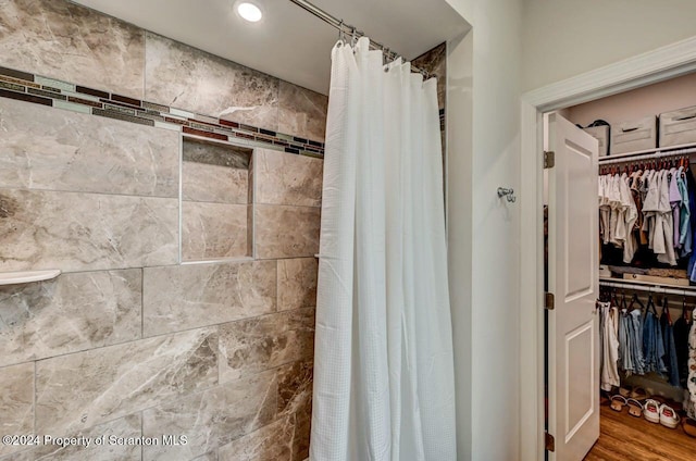 bathroom with hardwood / wood-style floors and a shower with curtain