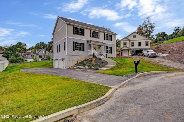 view of front of home with a garage and a front lawn