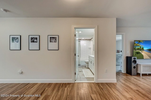 corridor with light hardwood / wood-style floors