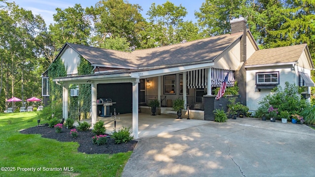 805 E Mountain Rd, Scranton, PA 18505 - view of front facade with concrete driveway, an attached garage, a chimney, a front lawn, and covered porch