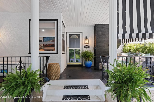 805 E Mountain Rd, Scranton, PA 18505 - view of exterior entry featuring stucco siding, a porch, and brick siding