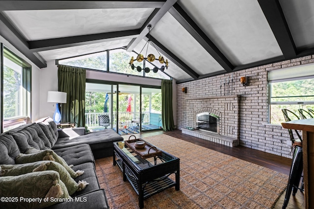 805 E Mountain Rd, Scranton, PA 18505 - living room featuring wood finished floors, plenty of natural light, a fireplace, a chandelier, and brick wall