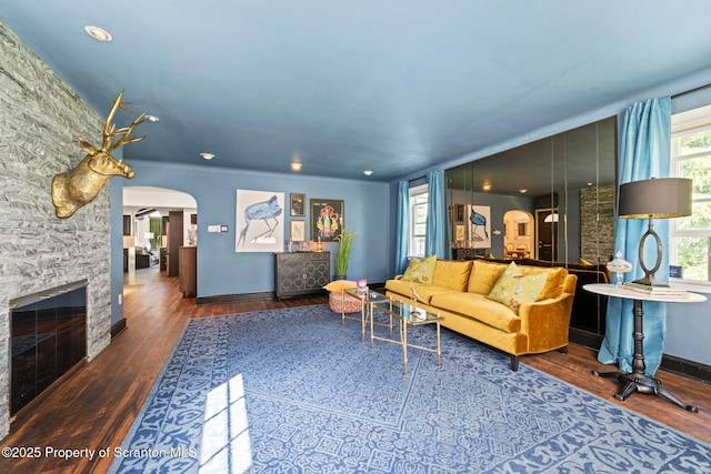 805 E Mountain Rd, Scranton, PA 18505 - living area with arched walkways, wood finished floors, and a stone fireplace