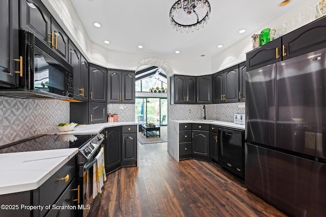805 E Mountain Rd, Scranton, PA 18505 - kitchen featuring black appliances, dark wood-style floors, decorative backsplash, recessed lighting, and light stone countertops
