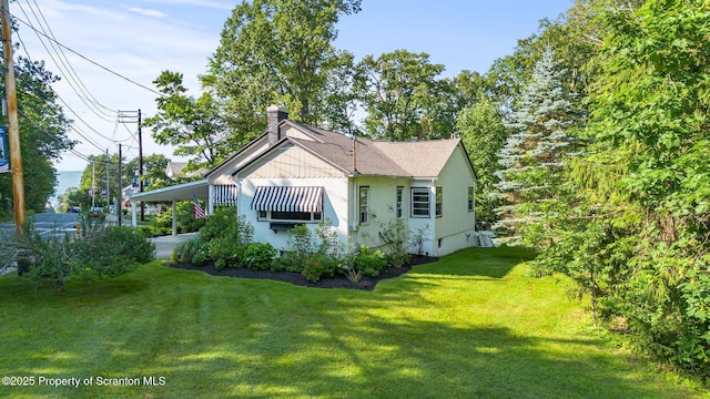 805 E Mountain Rd, Scranton, PA 18505 - view of home's exterior featuring a yard, a chimney, a carport, and stucco siding