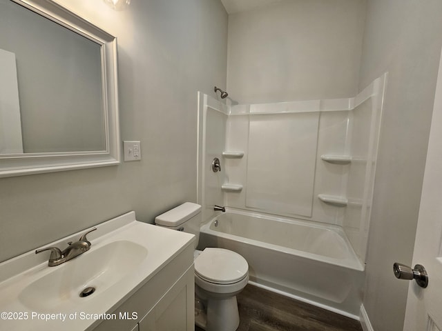 bathroom with vanity, toilet, shower / tub combination, and wood finished floors