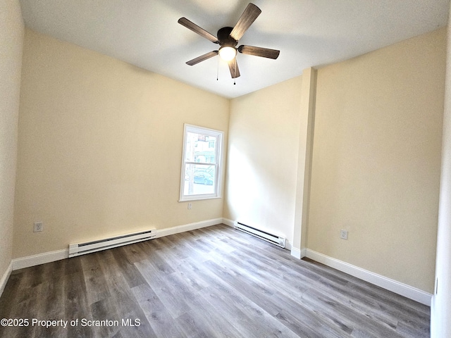 unfurnished room featuring ceiling fan, wood finished floors, and a baseboard heating unit