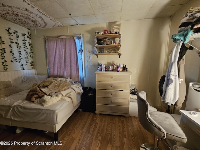 bedroom with dark wood-type flooring