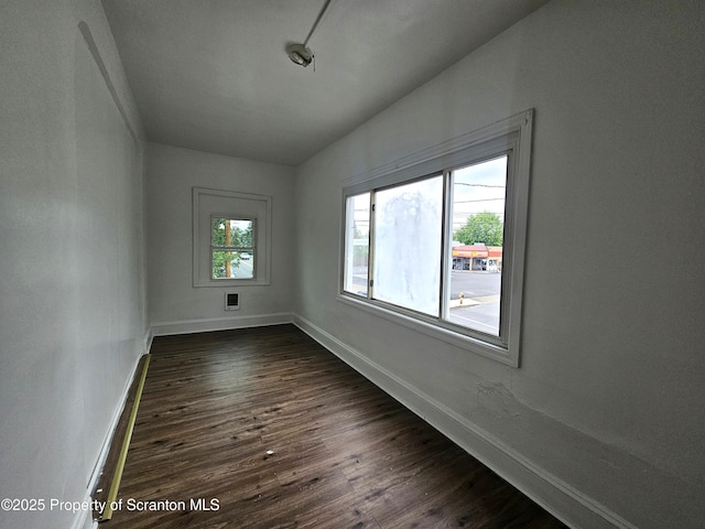 interior space with dark wood-style flooring and baseboards