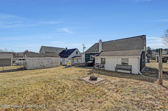 view of yard with an outdoor fire pit and fence