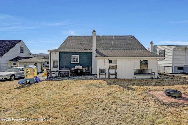 rear view of property with a patio area and a yard