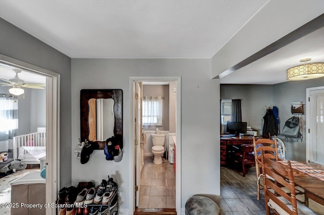 bathroom featuring toilet and ceiling fan