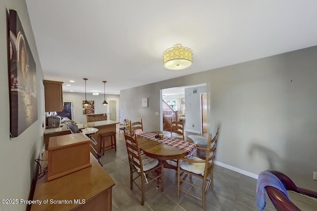 dining space with tile patterned floors and baseboards