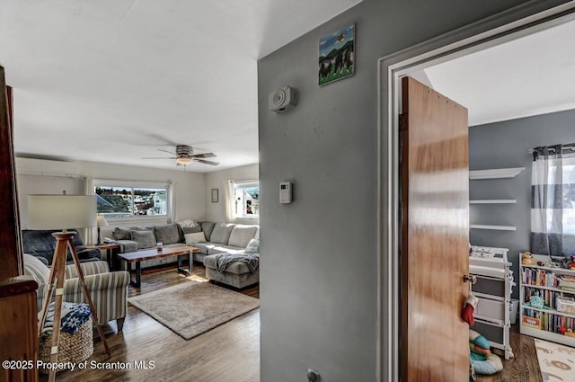 living room with wood finished floors and ceiling fan