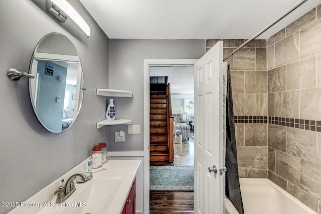 bathroom with a shower with shower curtain, wood finished floors, and vanity