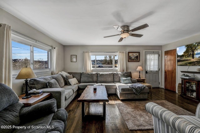 living area with wood finished floors and ceiling fan