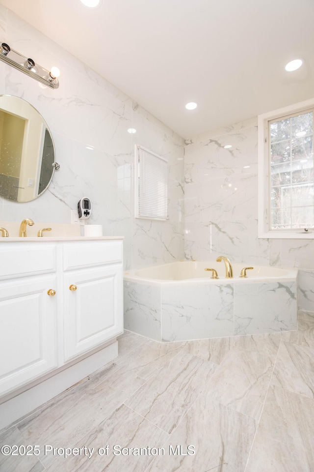 full bath with recessed lighting, a garden tub, and vanity