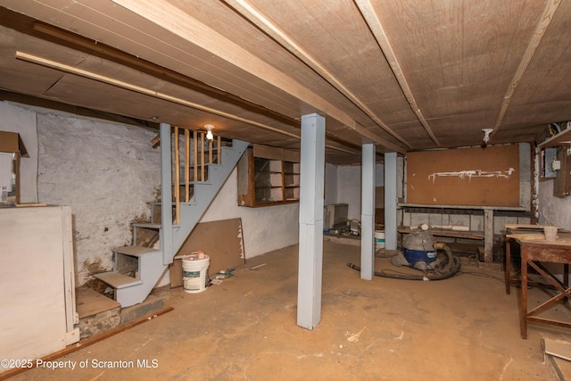 unfinished basement featuring stairway