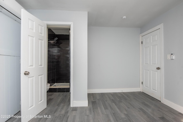 unfurnished bedroom featuring baseboards and wood finished floors