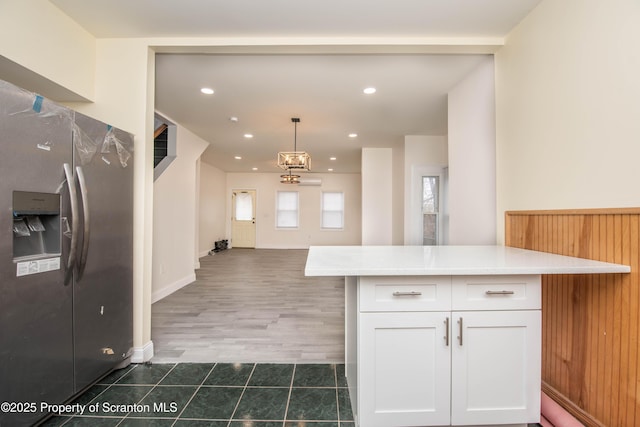 kitchen featuring white cabinets, recessed lighting, tile patterned floors, stainless steel fridge with ice dispenser, and light countertops